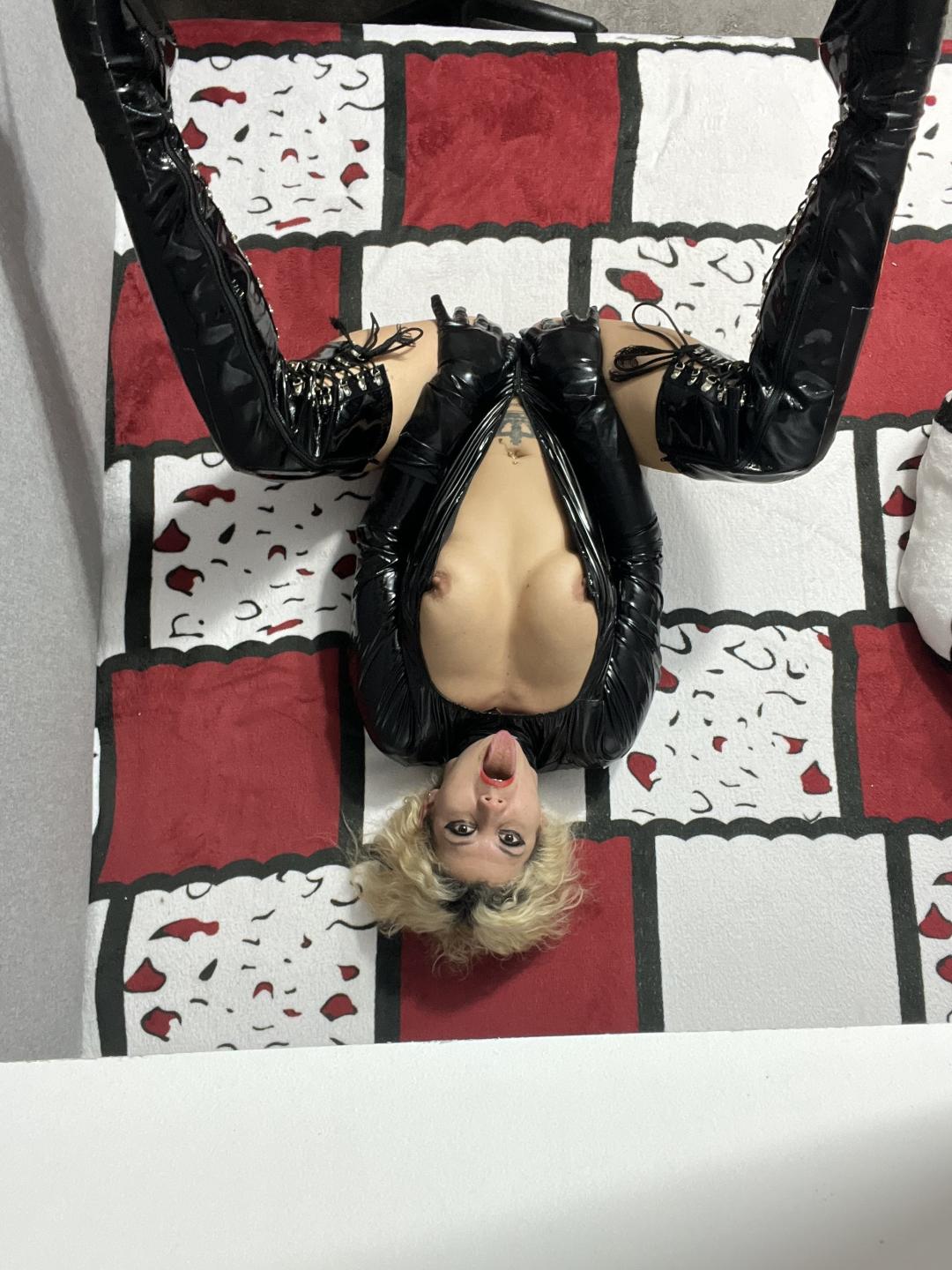 Tall blonde milf dominatrix is a ruthless master into femdom and has a huge BBC dildo attached to peg her obedient male slaves. Wears black latex suits and leather boots and loves to train her slaves. Has a whip and often ties it on her mature ass first while having a gag ball in her mouth drooling